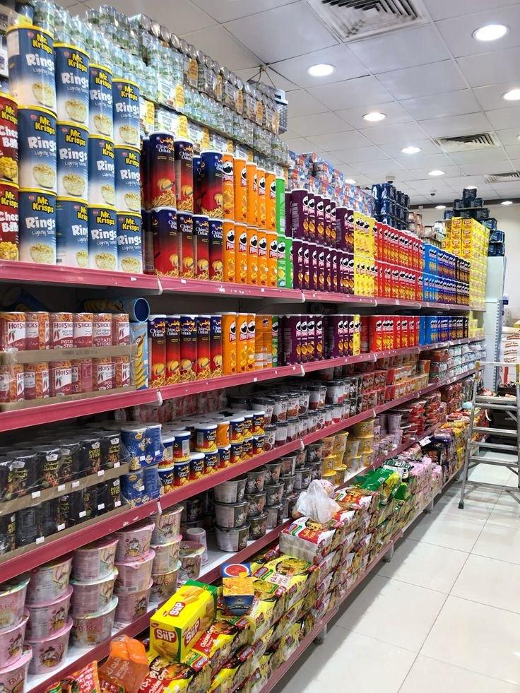 Tall shelves stocked with tins, sauces, snacks and specialty imports